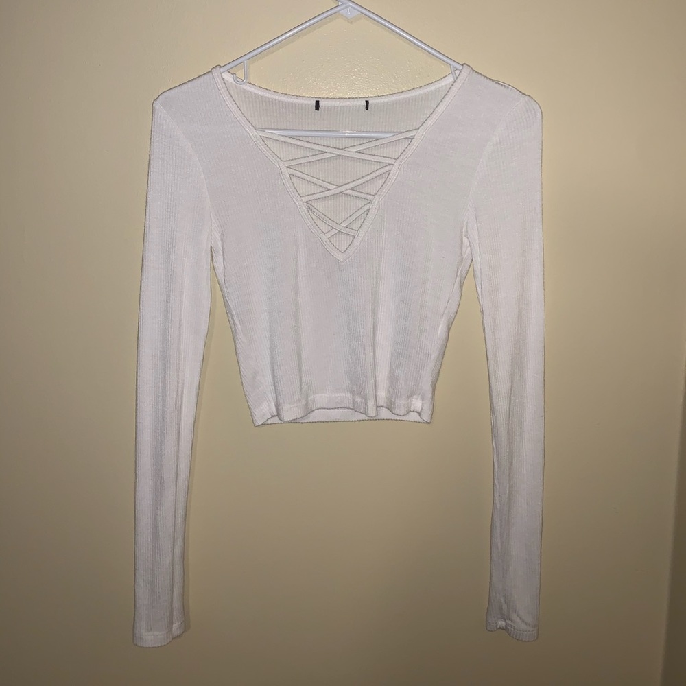 A white, cropped long sleeve shirt